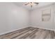 Bright bedroom featuring wood-look floors and a window with blinds at 17962 W Vogel Ave, Waddell, AZ 85355