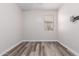 Simple bedroom with wood-look floors and a window with blinds at 17962 W Vogel Ave, Waddell, AZ 85355