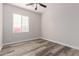 Bright bedroom with wood-look floors and window at 17962 W Vogel Ave, Waddell, AZ 85355