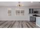 Dining area with wood-look flooring and stylish light fixture at 17962 W Vogel Ave, Waddell, AZ 85355