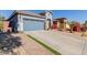 House exterior showcasing a two-car garage and a neatly landscaped yard at 17962 W Vogel Ave, Waddell, AZ 85355