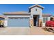 Single-story home with a two-car garage and well-maintained landscaping at 17962 W Vogel Ave, Waddell, AZ 85355