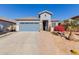 Single-story home with two-car garage and landscaped front yard at 17962 W Vogel Ave, Waddell, AZ 85355