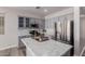 Modern kitchen with gray cabinets, marble countertops and stainless steel appliances at 17962 W Vogel Ave, Waddell, AZ 85355