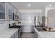 Modern kitchen with gray cabinets, marble countertops, and stainless steel appliances at 17962 W Vogel Ave, Waddell, AZ 85355