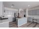 Modern kitchen featuring gray cabinets, marble countertops, and a center island at 17962 W Vogel Ave, Waddell, AZ 85355