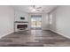 Living room with fireplace, wood-look floors, and sliding glass doors at 17962 W Vogel Ave, Waddell, AZ 85355