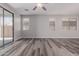 Living room featuring sliding glass doors, wood-look floors, and ample natural light at 17962 W Vogel Ave, Waddell, AZ 85355