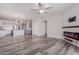 Open concept living area with kitchen, island, and modern fireplace at 17962 W Vogel Ave, Waddell, AZ 85355