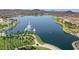 Aerial view of community lake with fountains and palm trees at 18212 W East Wind Ave, Goodyear, AZ 85338