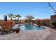 Inviting kidney-shaped pool with a waterfall feature, surrounded by a spacious patio at 18212 W East Wind Ave, Goodyear, AZ 85338