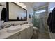 Elegant bathroom with double vanity, walk-in shower, and modern fixtures at 18212 W East Wind Ave, Goodyear, AZ 85338