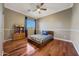 Cozy bedroom with hardwood floors and a ceiling fan at 18212 W East Wind Ave, Goodyear, AZ 85338