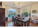 Elegant dining room with hardwood floors, chandelier, and backyard views at 18212 W East Wind Ave, Goodyear, AZ 85338