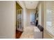 Well-lit hallway with tile flooring and access to other rooms at 18212 W East Wind Ave, Goodyear, AZ 85338