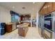 Modern kitchen with granite island, stainless steel appliances, and hardwood floors at 18212 W East Wind Ave, Goodyear, AZ 85338