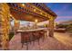 Rustic outdoor bar with stone details and seating at 18212 W East Wind Ave, Goodyear, AZ 85338