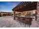 Large outdoor kitchen with bar seating and grill at 18212 W East Wind Ave, Goodyear, AZ 85338