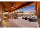 Covered patio with outdoor kitchen and seating area at 18212 W East Wind Ave, Goodyear, AZ 85338