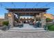 Relaxing covered patio with seating and fireplace at 18212 W East Wind Ave, Goodyear, AZ 85338