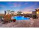 Relaxing pool area with fire feature and lush landscaping at 18212 W East Wind Ave, Goodyear, AZ 85338