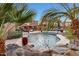 Relaxing pool area with lounge chairs and a tranquil waterfall feature at 18212 W East Wind Ave, Goodyear, AZ 85338