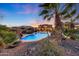 Relaxing pool area with lush landscaping and a waterfall feature at 18212 W East Wind Ave, Goodyear, AZ 85338