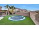 Circular trampoline sits on the lush, green artificial turf at 18212 W East Wind Ave, Goodyear, AZ 85338