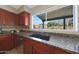 Kitchen with granite countertops, double sink, and backyard view at 18239 N 46Th St, Phoenix, AZ 85032