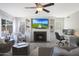 Cozy living room with fireplace, built-in shelves, and workspace at 18239 N 46Th St, Phoenix, AZ 85032