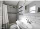 Renovated bathroom featuring subway tiles, gray accent tiles, and a modern shower at 1865 W 3Rd Pl, Mesa, AZ 85201