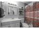 Well-lit bathroom with white vanity, decorative shower curtain, and modern fixtures at 1865 W 3Rd Pl, Mesa, AZ 85201