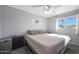 Bright bedroom featuring a ceiling fan and a window with natural light at 1865 W 3Rd Pl, Mesa, AZ 85201