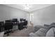 Well-lit bedroom with gray sofa, carpet floors, and workspace at 1865 W 3Rd Pl, Mesa, AZ 85201