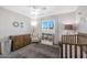 Bedroom featuring a crib, dresser, chair, and bright natural light at 1865 W 3Rd Pl, Mesa, AZ 85201