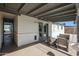 Relaxing covered patio with neutral-toned furniture, perfect for outdoor entertaining and enjoyment at 1865 W 3Rd Pl, Mesa, AZ 85201