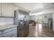 Spacious living area with stainless steel refrigerator and view of the living room at 1865 W 3Rd Pl, Mesa, AZ 85201