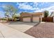 Tan house with three car garage and desert landscaping at 1875 E Stephens Dr, Tempe, AZ 85283