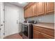 Laundry room with washer, dryer, and wood cabinets at 1875 E Stephens Dr, Tempe, AZ 85283