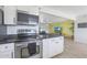 Modern kitchen features stainless steel appliances and white cabinetry at 2008 W Campbell Ave, Phoenix, AZ 85015