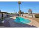 Kidney shaped pool with surrounding patio at 2008 W Campbell Ave, Phoenix, AZ 85015