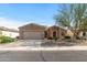 One-story house with tan exterior, two-car garage, and desert landscaping at 20533 N Sequoia Crest Dr, Surprise, AZ 85387