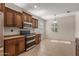 Kitchen with dark wood cabinets, granite countertops, and stainless steel appliances at 20533 N Sequoia Crest Dr, Surprise, AZ 85387