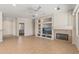 Living room with tile floors, fireplace, and built-in entertainment center at 20533 N Sequoia Crest Dr, Surprise, AZ 85387