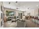 Living room with tiled floors, staged furniture, and access to patio at 20533 N Sequoia Crest Dr, Surprise, AZ 85387