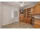 Home office with built-in wood shelving and desk at 20533 N Sequoia Crest Dr, Surprise, AZ 85387