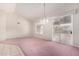 Dining room with pink carpeting and sliding glass doors to patio at 20811 N 148Th Dr, Sun City West, AZ 85375