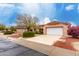 House exterior with a white garage door and well-maintained landscaping at 20811 N 148Th Dr, Sun City West, AZ 85375