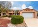 House exterior with a white garage door and well-maintained landscaping at 20811 N 148Th Dr, Sun City West, AZ 85375