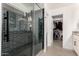 Modern bathroom with a walk-in shower and dark tile at 21054 N 74Th Ln, Glendale, AZ 85308